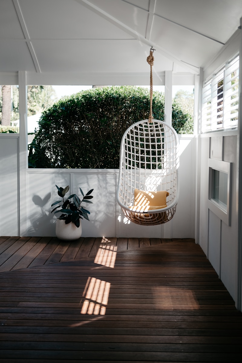 white bird cage on brown wooden floor